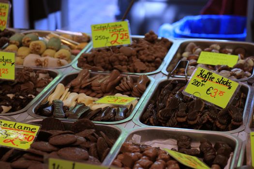 Chocolates on display on a confectioner's market stall (tags: prices and product information in Dutch, fudge and coffee candy bars)