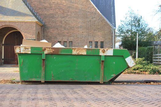 Loaded dumpster near a construction site, home renovation