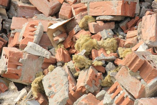 Pile of broken red bricks on construction site