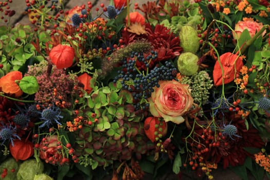 Mixed autumn flower arrangement: various flowers in different autumn colors for a fall wedding