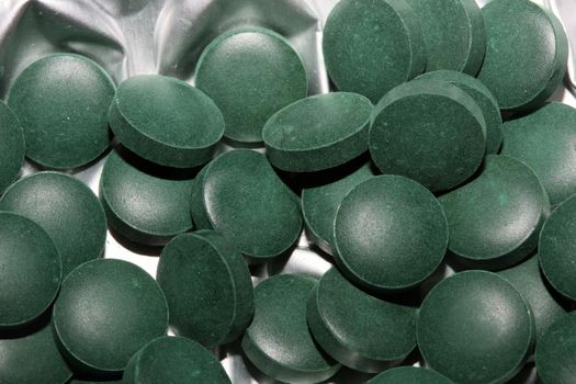 Medical green round vitamins spirulina platensis healthy super food close up background high quality big size prints