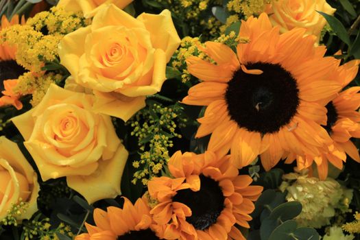 Mixed flower arrangement: various flowers in different shades of yellow for a wedding