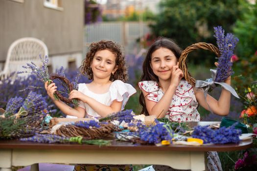 Girls make homemade lavender wreaths as a decor for home or present