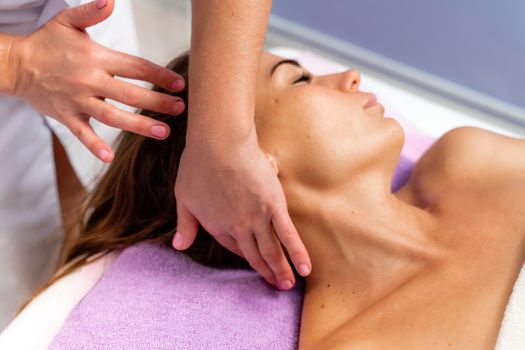 Facial massage. A woman is given a massage in a beauty salon. Close-up.