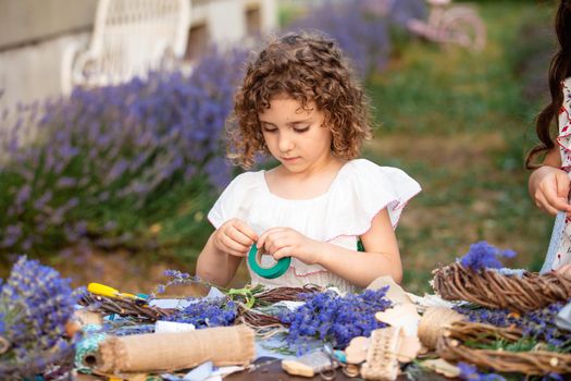 Girl creates homemade lavender wreath as a decor for home or healthy present