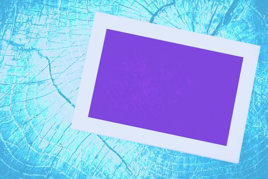 a rigid structure that surrounds or encloses something such as a door or window. Purple screen neon and white frame TV monitor on an azure blue wooden wall