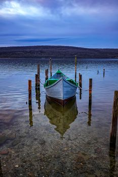 Lonely wooden boat moored at shore