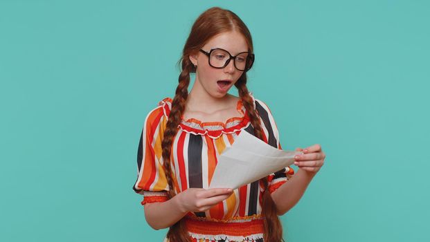 Girl open envelope take out letter reads it feel happy. Career growth advance promotion, bank loan approve, monetary award long-awaited invitation great news. Girl isolated on blue studio background