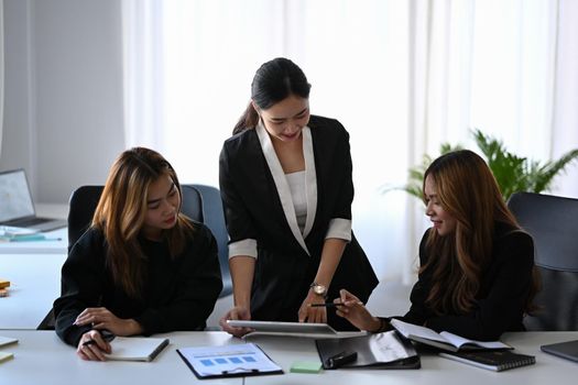 Group of young business people working on new project together in modern office.