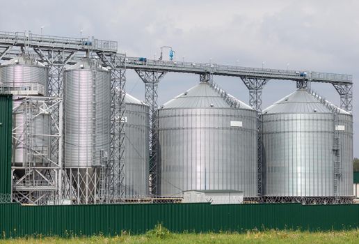 Modern large granary agro silos elevator on agro-processing manufacturing plant for processing drying cleaning and storage of agricultural products, flour, cereals and grain.