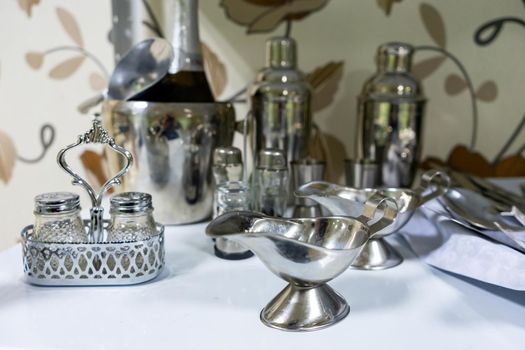 A set of various cutlery and objects. A variety of shiny metal cutlery.