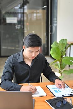 Young businessman working in comfortable workplace.