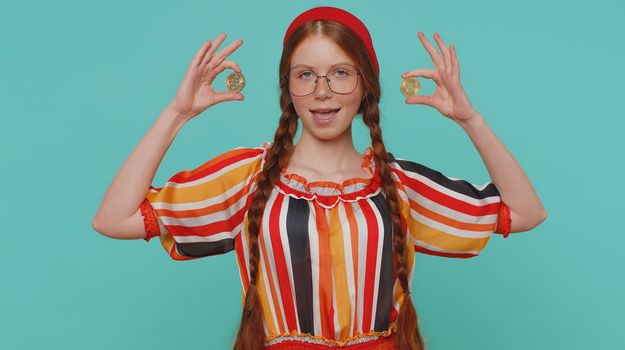 Redhead Girl Winner Showing Golden Bitcoins. Career Wealth Cryptocurrency Investment Mining Future Technology. Young Ginger Child Fooling Making Faces. Happy Businesswoman Isolated On Blue Background