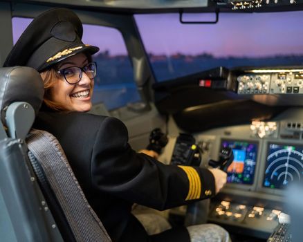 Female pilot on board the aircraft. Caucasian woman in flight simulator