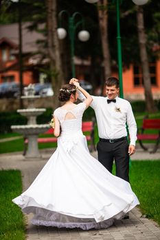 Happy bride and groom after wedding ceremony walking at the park and have photoshoot