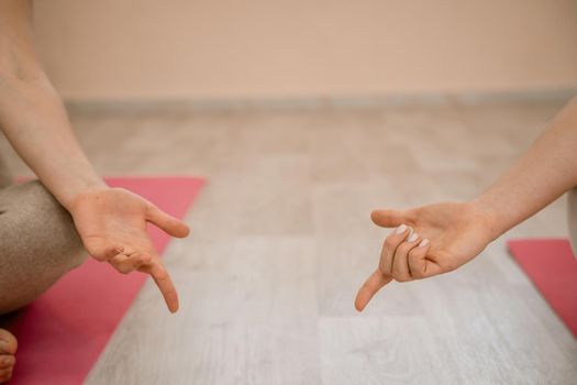 Two beautiful women do yoga, sports in the gym. The concept of grace and beauty of the body