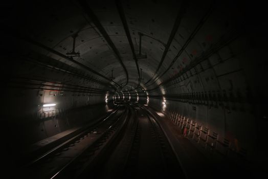 Front cabin view of driverless metro train moving through underground tunnel. Automated advanced transportation system, subway in Beijing, China. High quality photo