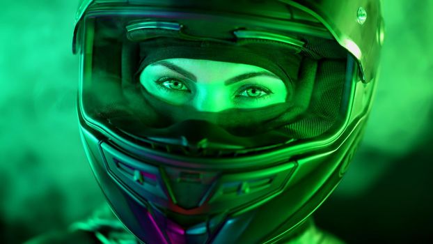 Young female motorcyclist woman in closed motorcycle helmet. Driver biker looking to camera under green colorful neon light with smoke or steam at night. Amazing aesthetic portrait. High quality photo