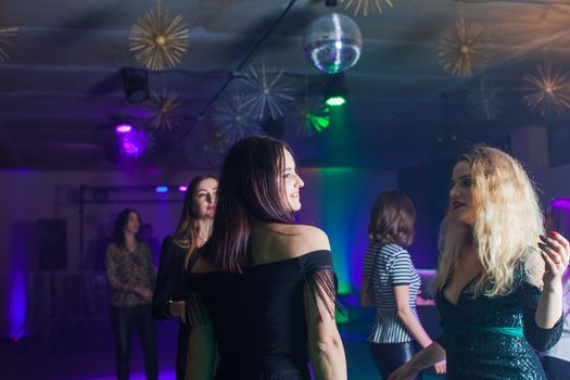 Group of dancing women enjoying night in club