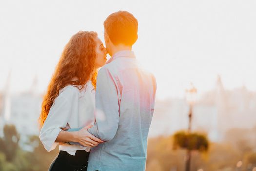 Young couple spending intimate time together in city. Sunset light, sun flares. Lovers enjoying on date. Woman and man holding hands. Love, family, care concept. High quality photo