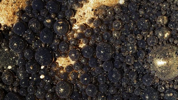 Top view abstract of black gold bubbles in paint. Inks, spheres, oil. Shapes. Detailed background, beautiful design, balloons texture. High quality photo