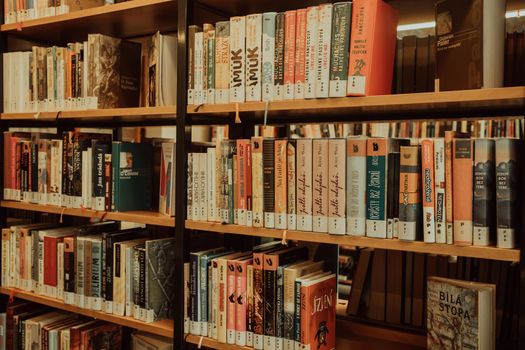 Prague, Czech Republic - July, 2022. Public Municipal Library with colorful paper books on shelves. Education, science, literature concept. High quality photo