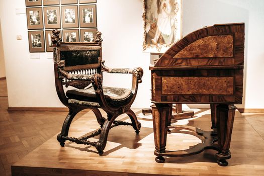 Prague, Czech Republic - July 2022. Alphonse Mucha Museum. The painter's desk, chair and tools. Gallery dedicated to renowned painter, illustrator, graphic artist. High quality photo