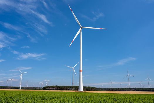 Wind energy plants in front of a blue sky in Germany