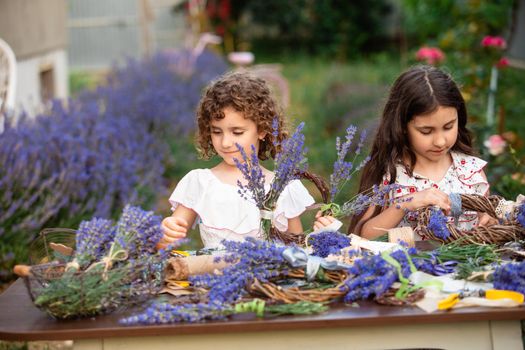 Girls make homemade lavender wreaths as a decor for home or present