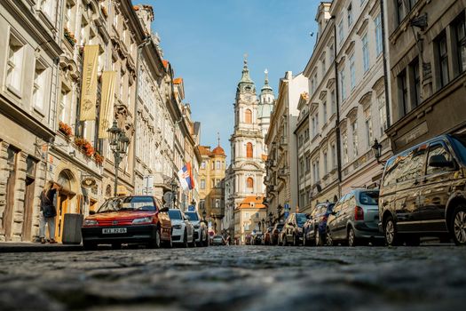 Prague, Czech Republic - July 2022. Beautiful cozy narrow street in old town. Amazing european architecture, historical facades of traditional buildings. High quality photo
