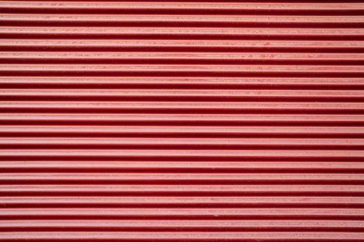 Parallel red vertical lines background. Metallic texture, natural abstract stripes. Perfect for mock-up and design. Seamless pattern. High quality photo