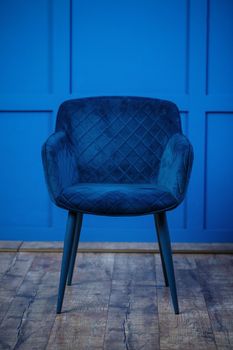 Blue chair, soft upholstery on the chair, blue background