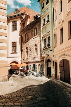 Prague, Czech Republic - July 2022. Beautiful cozy narrow street in old town. Amazing european architecture, historical facades of traditional buildings. High quality photo