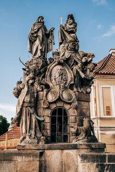 Prague Turk Statues of John of Matha on famous medieval Charles Bridge - Karlov bridge across Vltava river. Historic, old district of european capital. High quality photo