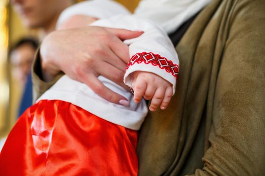 Baby hand on a white coverlet