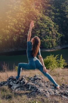 Yogi woman on top of high mountain doing yoga practice with deep breathing. Stretching body. Wild nature, free human. Freedom, Healthy lifestyle, everyday practice. High quality photo