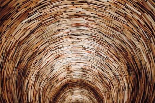 Prague, CZECH REPUBLIC - July 2022. Endless book tunnel tower in public municipal library. Well of books, mirrors used to create effect. colorful paper literature. High quality photo