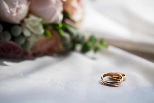 Gold wedding rings for newlyweds on wedding day