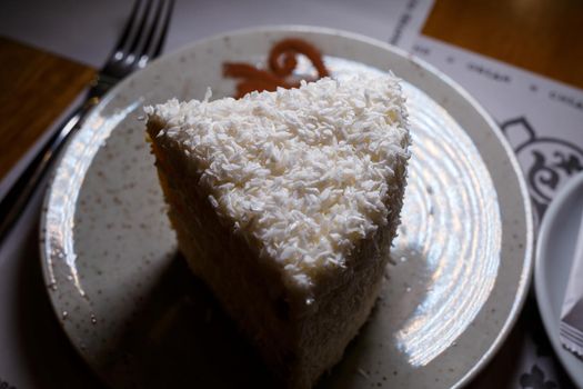 Delicious sweet piece of coconut cake with biscuit cakes