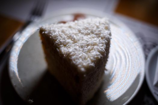 Delicious sweet piece of coconut cake with biscuit cakes