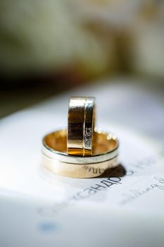 Gold wedding rings for newlyweds on wedding day