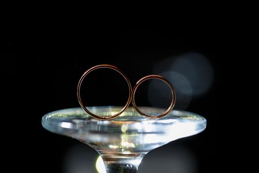 Gold wedding rings for newlyweds on their wedding day. Jewelry for the holiday of a couple in love