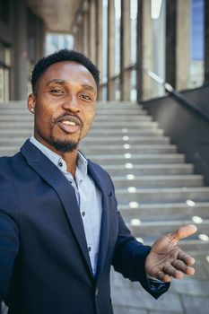 african businessman uses video call looking at camera and communicating with colleagues