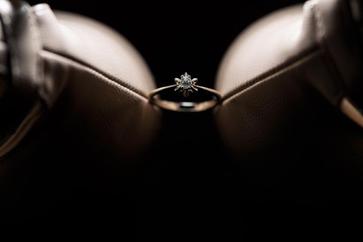 Bride's engagement ring on wedding day with beautiful holiday shoes