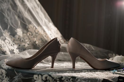 Bride's engagement ring on wedding day with beautiful holiday shoes