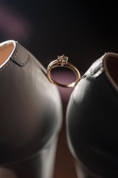 Bride's engagement ring on wedding day with beautiful holiday shoes