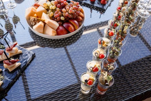 Buffet table for guests at a banquet with various snacks and sandwiches