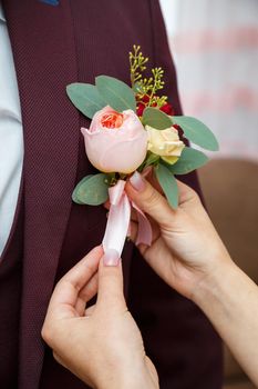 Beautiful wedding bouquet of flowers in the hands of the newlyweds