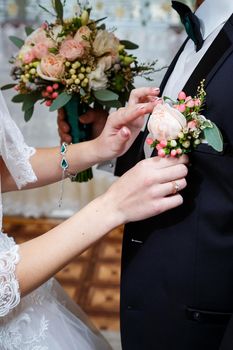 Beautiful wedding bouquet of flowers in the hands of the newlyweds