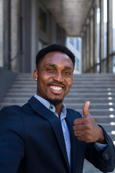 african businessman uses video call looking at camera and communicating with colleagues